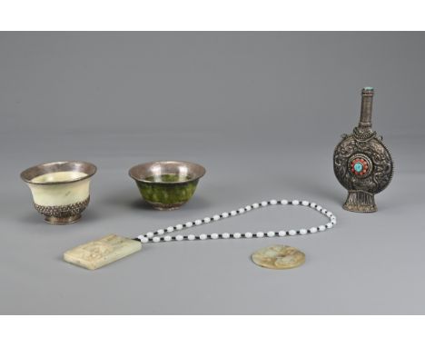 A GROUP OF CHINESE / TIBETAN JADE AND METAL ITEMS. To include a rectangular jade pendant carved in relief depicting a winged 