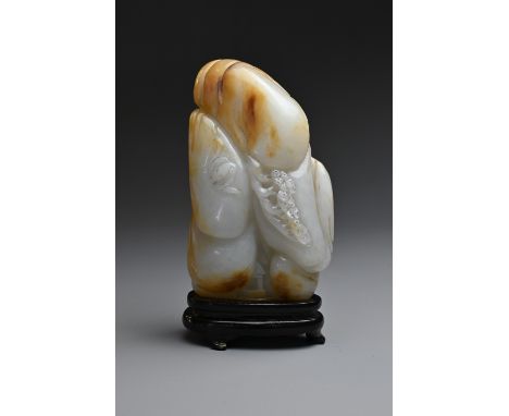A CHINESE JADE CARVING. Of greyish white tone with orange brown streaks, carved in relief figure and bat in a mountain landsc
