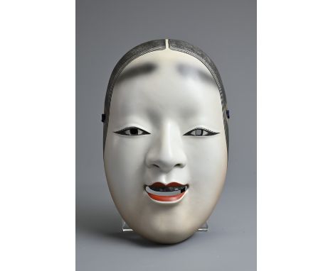 A JAPANESE PORCELAIN SIGNED OKAME NOH MASK. Signed in red overglaze enamel to reverse, with red lips and features picked out 