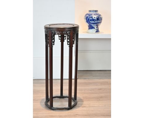 A 20TH CENTURY CHINESE CARVED HARDWOOD CIRCULAR JARDINIERE STAND. With rounded moulded top above fret Key pattern and foliate