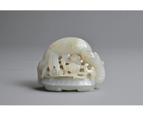 A CHINESE PALE CELADON JADE CARVING. Pierced and carved with a crane holding a branch in its beak with ruyi heads standing on
