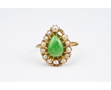 LADIES 22CT YELLOW GOLD CLUSTER DRESS RING. With claw set pear shaped jadeite cabochon and thirteen claw set semi-baroque see