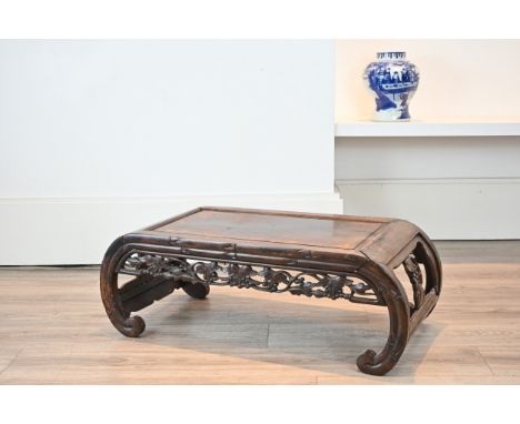 AN EARLY 20TH CENTURY CHINESE CARVED HARDWOOD LOW TABLE. Scroll ended with moulded top, carved with fruiting vine and bamboo 