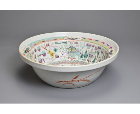 A LARGE CHINESE FAMILLE ROSE ENAMELLED PORCELAIN BASIN, 19TH CENTURY. Rounded sides with a stepped rim decorated with a peaco