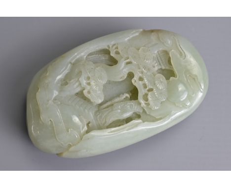 A CHINESE PALE CELADON JADE PEBBLE CARVING. Carved in deep relief with landscape scene with scholar standing under the moon a