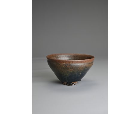 A CHINESE BLACK GLAZED HARE'S FUR POTTERY TEA BOWL, SONG DYNASTY. Deep rounded sides on a short foot covered in a black lustr