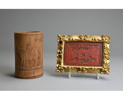 A CHINESE FRAMED CINNABAR LACQUER PANEL WITH BAMBOO BRUSH POT, 19/20TH CENTURY. The panel decorated with two figures in lands