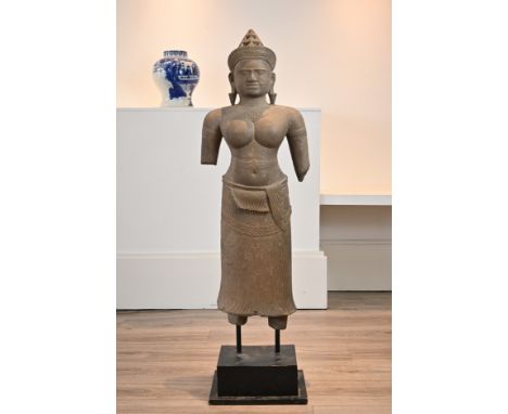A LARGE CAMBODIAN KHMER TYPE CARVED STONE FIGURE OF LAKSHMI. The Hindu Goddess Lakshmi, consort of Vishnu dressed in sampot t