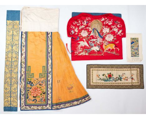 AN EARLY 20TH CENTURY CHINESE EMBROIDERED ORANGE SILK SKIRT, A RED SILK EMROIDERED CHAIR COVERING A PAIR OF SMALL EMBROIDERED