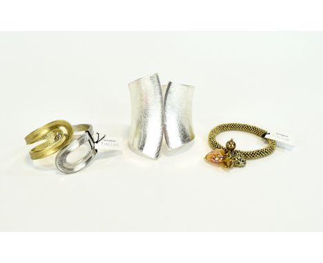 Statement Cuff And Bracelets Three in total to include large silver tone hinged statement cuff with textural surface. Also sm