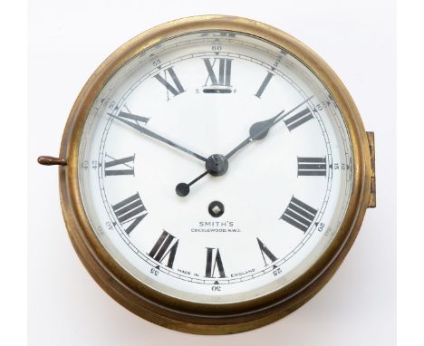 A 20th century ships brass bulkhead clock, having 8-day movement with enamelled dial, roman and arabic numerals, minute track