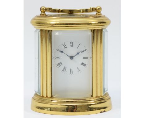 A miniature brass case carriage clock, circa 20th century, of oval form having a French 8 day movement, 8cm tall. In good cos