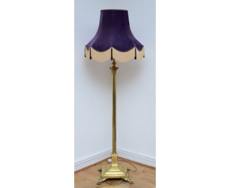 A late 20th century brass standard lamp with fabric shade, in the form of a Corinthian column, acanthus leaf capital over ree