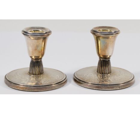 A silver pair of desk candlestick's, Birmingham 1961, with engine turned and engraved floral decoration, loaded, 8cm. 