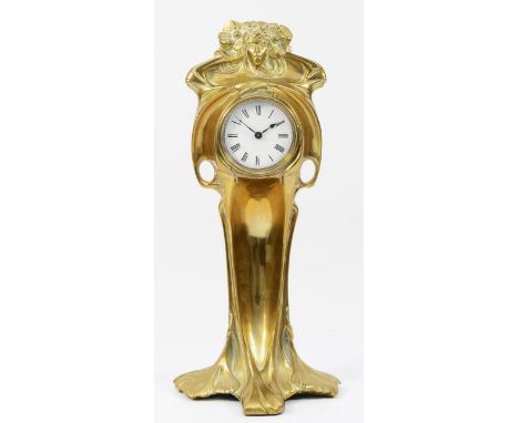 An Art Nouveau gilt brass 8 day mantel clock, in the form of a cloaked female figure holding a clock, 31cm tall. Very good co