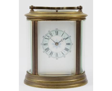 An early 20th century brass case carriage clock, of oval form with painted dial and Roman numerals, having 8 day repeater mov