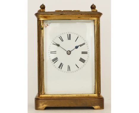 A 20th century brass carriage clock, the enamelled dial with Roman and Arabic numerals, having an 8 day movement striking on 