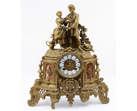 A 20th century Italian Imperial style gilt cast brass mantel clock, two lovers above scrolling decoration, the 8 day movement