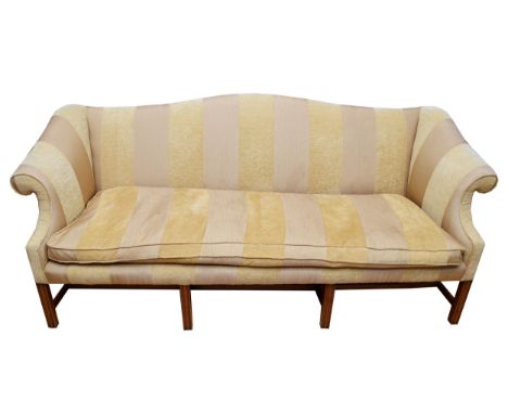 A late 19th century camelback three seater sofa, upholstered in gilt damask fabric, having out-scrolling arms raised on splay