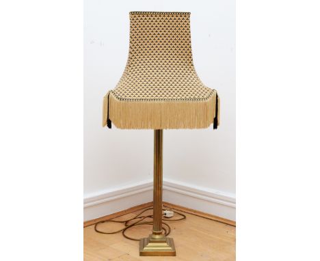 A gilt brass table lamp in the form of Corinthian column on a square stepped base, with tassel fabric shade.85cm tall. 