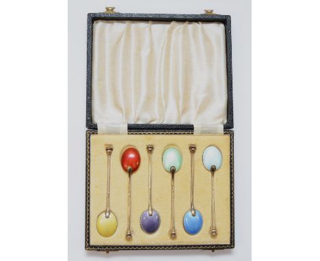 A silver gilt and enamel set of seal top coffee spoons, Birmingham 1955/6, with guilloche enamel bowls, 59gm, case.All enamel