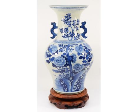 A large Chinese blue and white porcelain vase, circa 19th century Kangxi Dynasty, of baluster form, painted with a spray of l