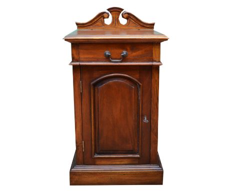 A Victorian mahogany pot cupboard, single drawer over panelled door opening to reveal a single shelf, raised on a plinth base