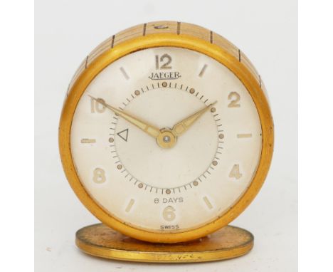 Jaeger, a gilt metal 8  day travel alarm clock, model 51, mounted on a stand, with original 1956 receipt for £8.00, 46mm, cas