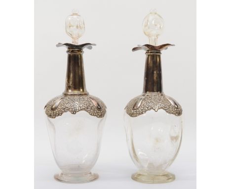 An Edwardian silver mounted pair of spirit decanters, by William Hutton &amp; Sons Ltd., Birmingham 1901/02, the tapering gla