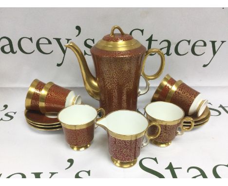 A Royal Adderley coffee set with giltwork decoration on a red and white ground. Shipping category D.