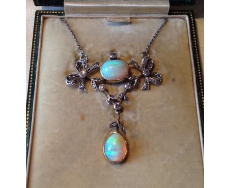 Edwardian opal and diamond set necklace. 1 oval and 1 pear-shape opals (total weight approx. 3.8ct) between 2 diamond set bow