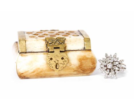 DIAMOND CLUSTER RINGthe tiered snowflake motif bezel set with a central round brilliant cut diamond of approximately 0.18 car