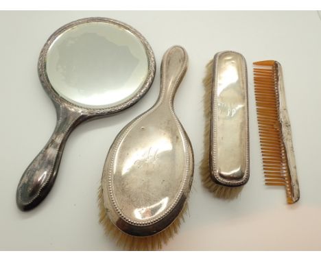 Hallmarked silver brushes and comb and a plated hand mirror