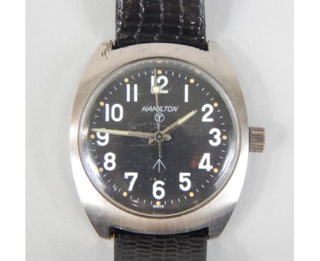 A Hamilton steel military wristwatch, the black dial with maker's name and military arrow emblem, later strap, etc.