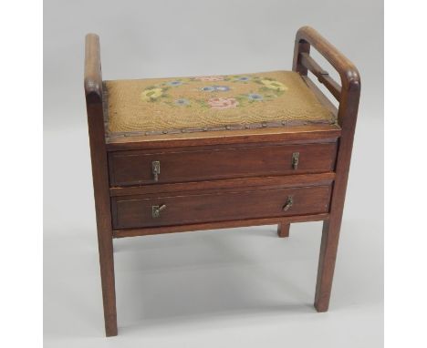 An early 20thC mahogany piano stool, with a padded seat above two drawers