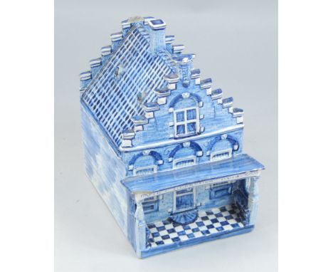 A 19thC Delft tin glazed model of a house, painted in blue, titled to the top In't Makkumer Huis, 18cm high, 12cm wide