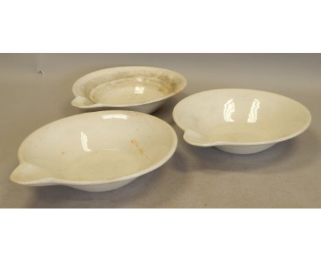 A set of three Minton ceramic wash bowls, each with spout to one end, painted marks to underside, 53cm diameter.  Provenance: