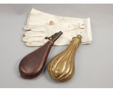 A copper and brass powder flask, a leather shot flask and a pair of kid gloves