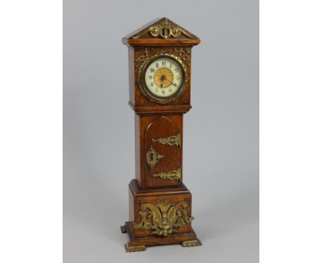 A late 19th/early 20thC oak and gilt metal mounted miniature longcase clock, with a part enamelled dial on square feet, 34cm 