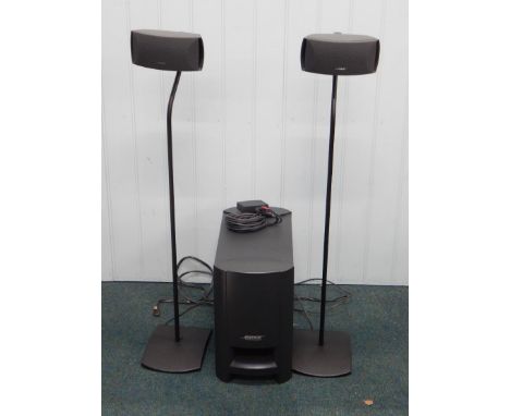 A Bose digital home theatre speaker system, comprising two small speakers, sub woofer, remote control etc.