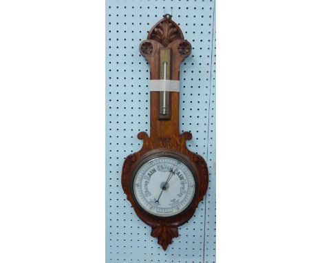An early 20thC aneroid barometer, in an oak case, the thermometer stamped "with compliments of Fergusson Pailin Ltd"