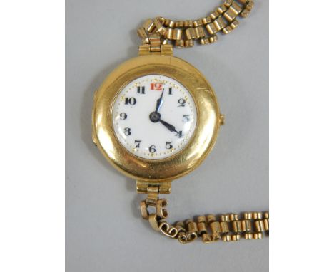 An 18ct gold ladies wristwatch, the round white enamel dial with blue hands, on expanding rolled gold strap, watch casing yel