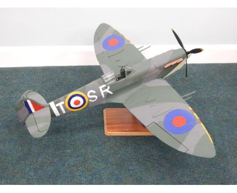 A working scale model of an RAF Spitfire, with battery operated lights, propeller, etc, on a mahogany veneered and chrome sta