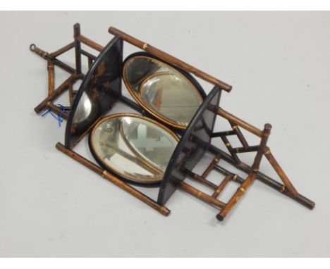 A late 19thC bamboo and ebonised corner wall bracket, with two bevelled oval plates, 81cm high.
