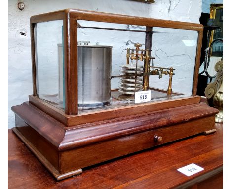 A Cassella of London barograph, marked 891 twelve diaphragm bellows, cased in bevelled glass, above drawer with spare charts,