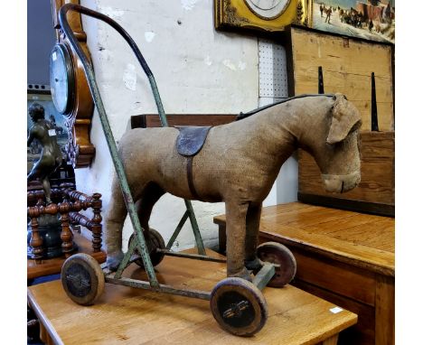 Juvenalia - A 1920's / 30's straw filled push along donkey/horse child's toy, leather capped hooves, metal handle with polych