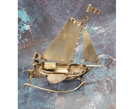 A Dutch silver coloured metal model, of a boat on rocker, 9.5cm high 