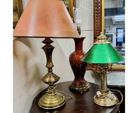 Lighting - three table lamps including a green shade library lamp, Sang De Bouf baluster gilt metal mounted lamp base and a t