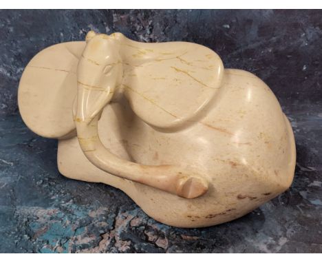 An unusual tribal carved hardstone elephant, over exaggerated ears and trunk 