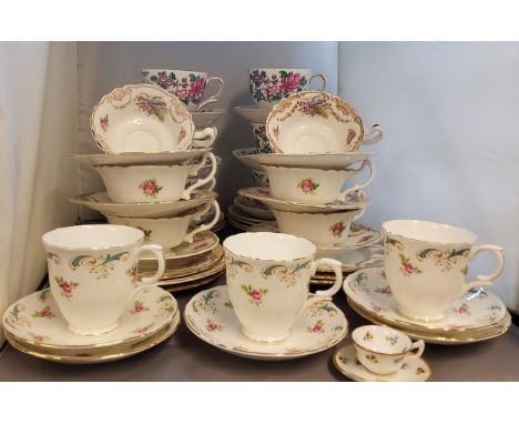 A Royal Doulton tea service, for six, printed with roses,&nbsp; Cupids's bow and arrow and gilt swags, printed marks;&nbsp; a